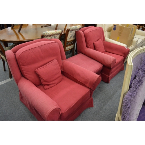 266 - A pair of red upholstered armchairs and matching footstool.