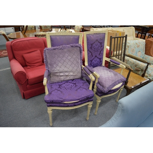 267 - A pair of cream painted high backed open armchairs with purple upholstery.