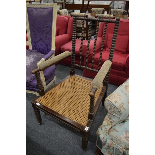 268 - A 19th century bobbin turned armchair with cane work seat.