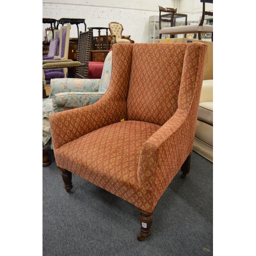 270 - A Victorian square shaped armchair on turned supports.