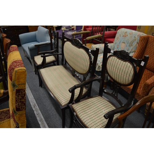 273 - An early 20th century mahogany stained three piece salon suite comprising settee and pair of armchai... 