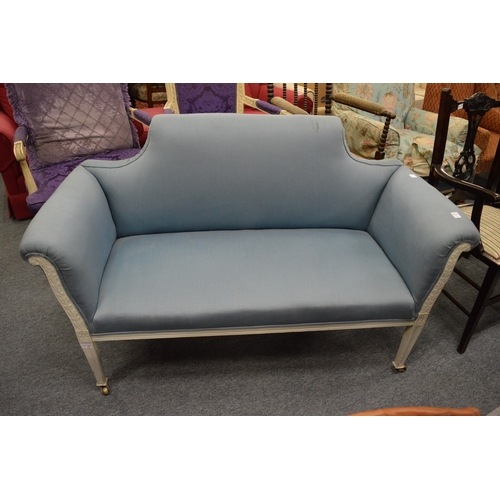 274 - A late Victorian salon settee with white painted frame and pale blue upholstery.