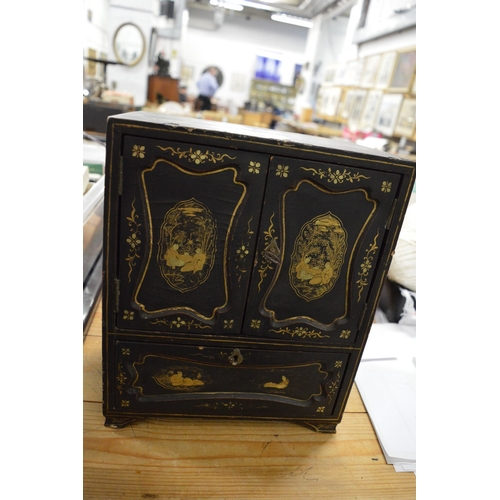 639 - A Japanese chinoiserie decorated lacquer table cabinet.