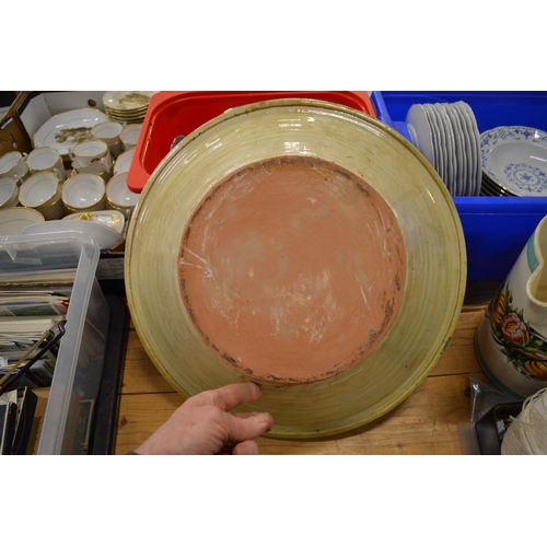 640 - A large Continental earthenware bowl with blue and green painted decoration.