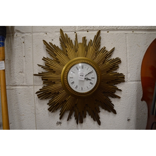 658 - A sunburst wall clock with quartz movement.