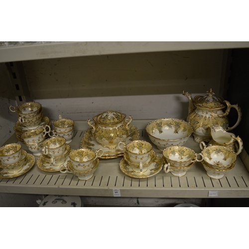 69 - A late 19th century gilt decorated part tea service.