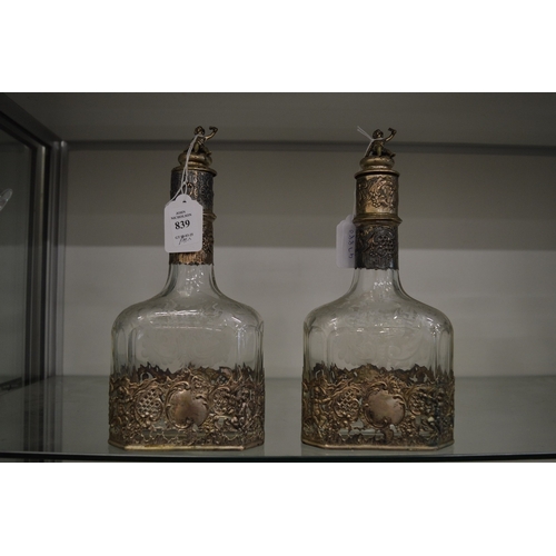 839 - A good pair of engraved and etched glass decanters with decorative white metal mounts.