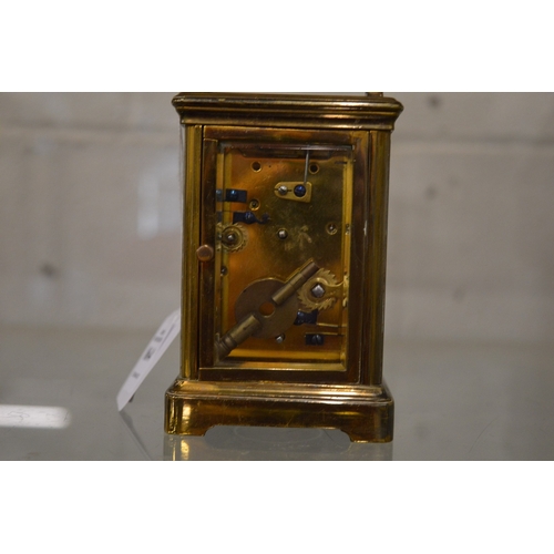 864 - A brass carriage clock with alarm.