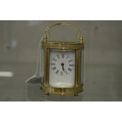 865 - A small oval shaped carriage clock with plated case.