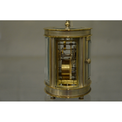 865 - A small oval shaped carriage clock with plated case.