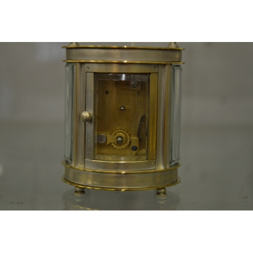 865 - A small oval shaped carriage clock with plated case.