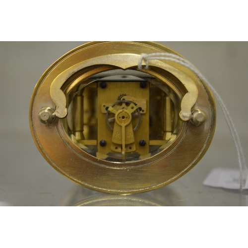 865 - A small oval shaped carriage clock with plated case.