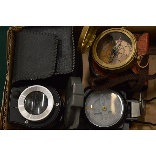 979 - Two compasses and a magnifying device.