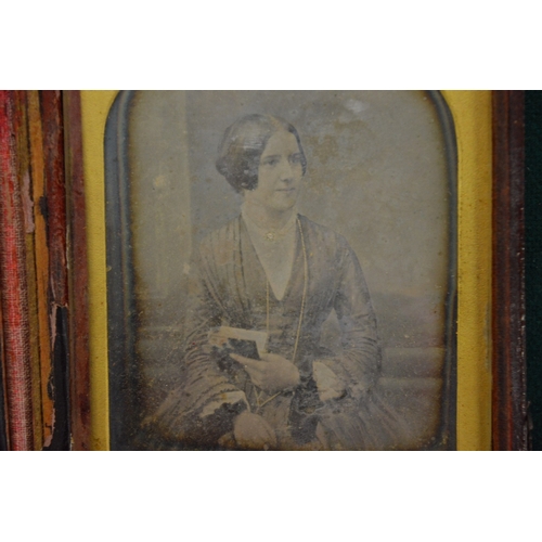 981 - An early photograph of a young lady in a travelling case.