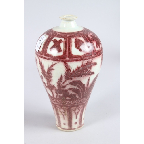 121 - A CHINESE PORCELAIN MEIPING SHAPE VASE with underglaze red decortion. 23cms high.