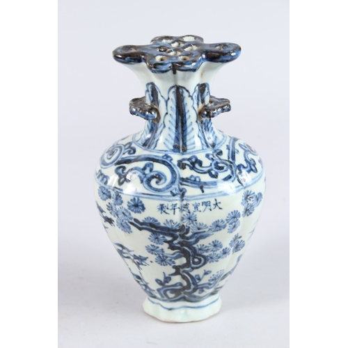122 - A CHINESE PORCELAIN BLUE AND WHITE VASE of moulded form, with pierced flower stem neck, painted with... 