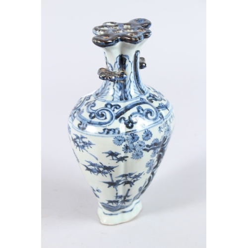 122 - A CHINESE PORCELAIN BLUE AND WHITE VASE of moulded form, with pierced flower stem neck, painted with... 