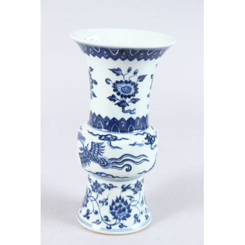 123 - A CHINESE PORCELAIN BLUE AND WHITE GU SHAPE VASE, painted with phoenix and flowers. 21.5cms high.... 