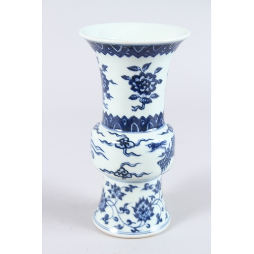 123 - A CHINESE PORCELAIN BLUE AND WHITE GU SHAPE VASE, painted with phoenix and flowers. 21.5cms high.... 