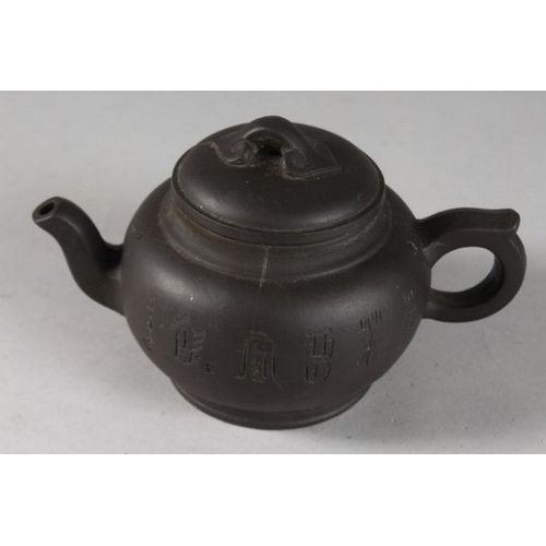 131 - A CHINESE BLACK YIXING TEAPOT, with impressed mark to base.