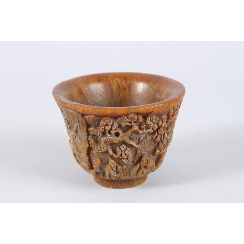 137 - A CHINESE CARVED HORN CIRCULAR BEAKER. 4.5ins diameter.