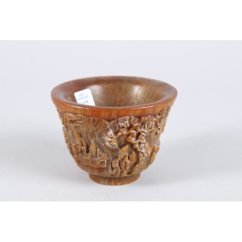 137 - A CHINESE CARVED HORN CIRCULAR BEAKER. 4.5ins diameter.