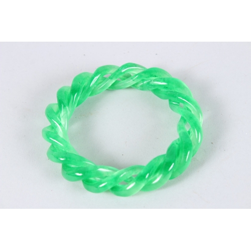 138 - A CHINESE APPLE GREEN JADE TWIT BANGLE. 3.5ins diameter.