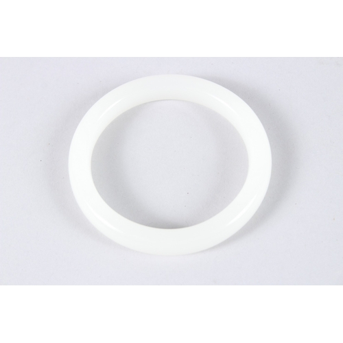 139 - A CHINESE WHITE JADE BANGLE. 3.25ins diameter.