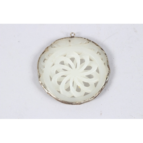 146 - A PIERCED JADE AND SILVER PENDANT. 2ins.