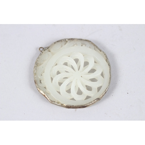 146 - A PIERCED JADE AND SILVER PENDANT. 2ins.