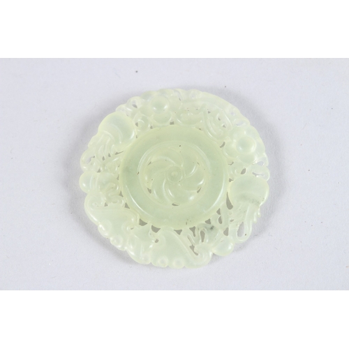 150 - A PIERCED JADE ROUNDEL. 1.75ins diameter.