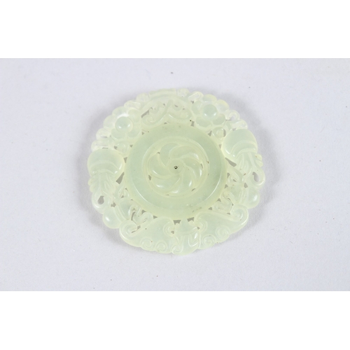 150 - A PIERCED JADE ROUNDEL. 1.75ins diameter.