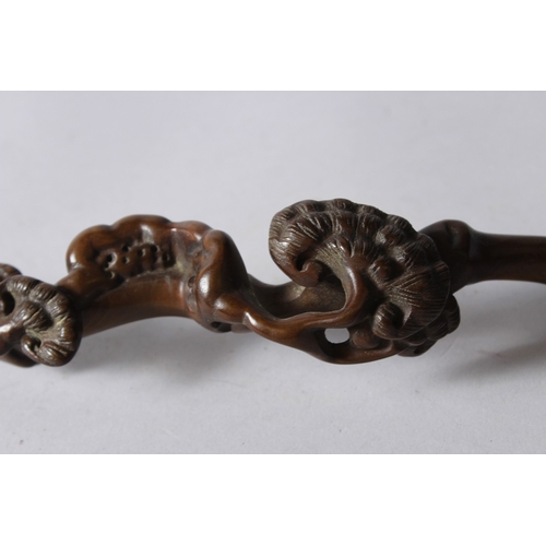 155 - A CHINESE CARVED WOOD RUYUI SCEPTRE, of naturalistic form. 33cms long.