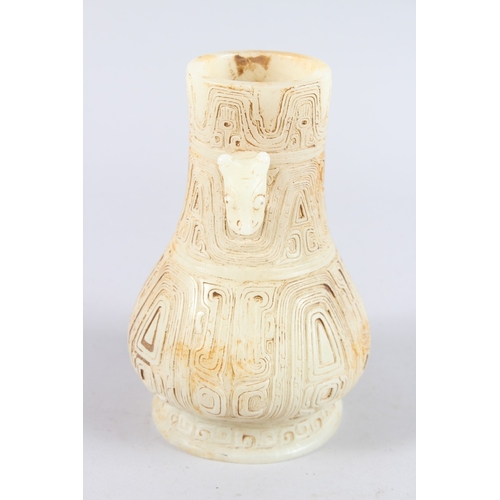 160 - A CHINESE ARCHAIC FORM CARVED JADEITE TWIN HANDLED VASE. 21cms high.