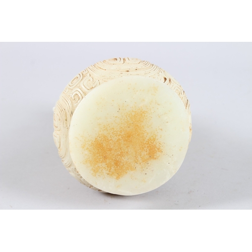 160 - A CHINESE ARCHAIC FORM CARVED JADEITE TWIN HANDLED VASE. 21cms high.