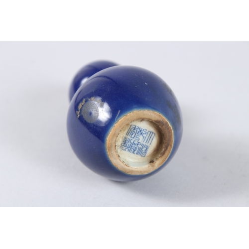 163 - A CHINESE PORCELAIN BLUE GROUND MINIATURE GOURD SHAPE VASE. 11cms high.