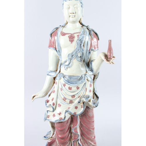 165 - A GOOD LARGE CHINESE POTTERY FIGURE OF A STANDING BUDDHA, one arm to their side, the other holding a... 