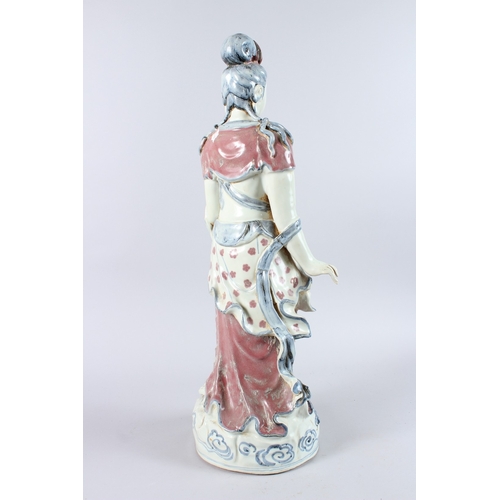 165 - A GOOD LARGE CHINESE POTTERY FIGURE OF A STANDING BUDDHA, one arm to their side, the other holding a... 