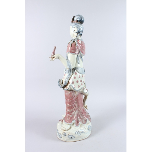 165 - A GOOD LARGE CHINESE POTTERY FIGURE OF A STANDING BUDDHA, one arm to their side, the other holding a... 