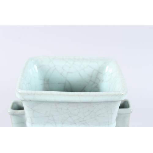 166 - A CHINESE CELADON CRACKLE GLAZE TWIN HANDLED PORCELAIN VASE, of square baluster form. 31cms high.... 