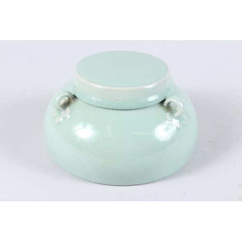 171 - A CHINESE CELADON GLAZED PORCELAIN BOWL AND COVER, with three loop handles. 15cms diameter.