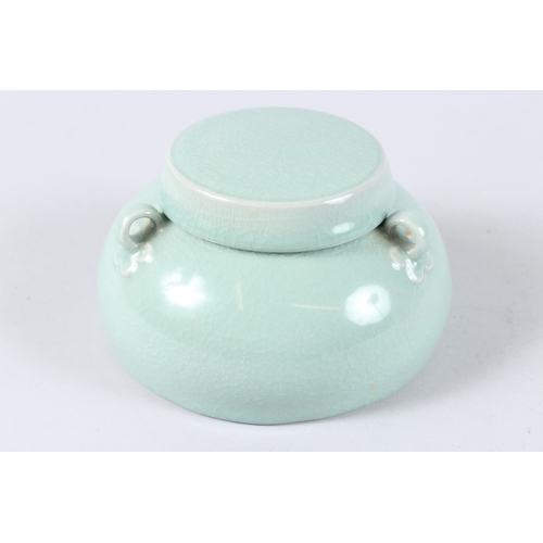 171 - A CHINESE CELADON GLAZED PORCELAIN BOWL AND COVER, with three loop handles. 15cms diameter.