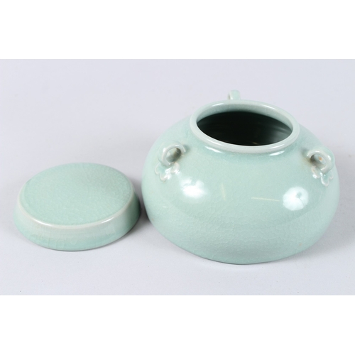 171 - A CHINESE CELADON GLAZED PORCELAIN BOWL AND COVER, with three loop handles. 15cms diameter.
