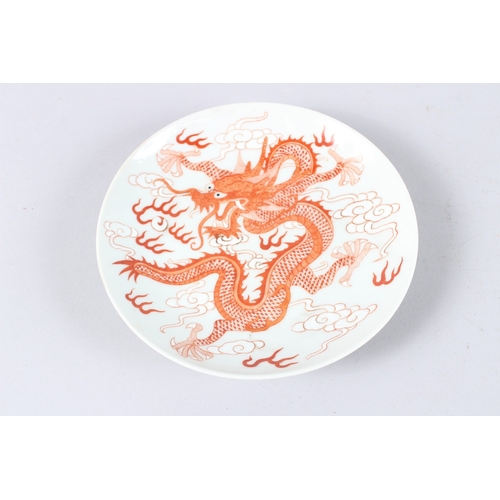 175 - A CHINESE PORCELAIN CIRCULAR DISH, painted in iron red depicting a dragon, six character mark to bas... 