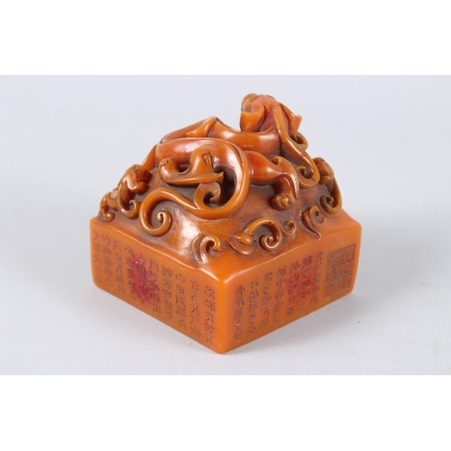 179 - A CHINESE CARVED HARDSTONE SQUARE SHAPED SEAL. 11cms wide.