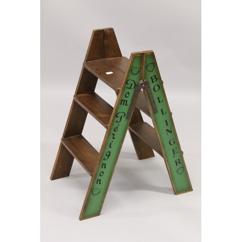 34 - A CHAMPAGNE WOODEN FOLDING LADDER. 2ft 10ins high.