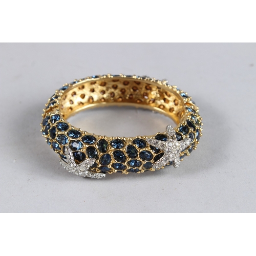 376 - A DIAMANTE BANGLE with black stones.