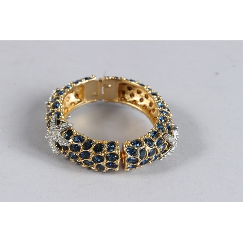 376 - A DIAMANTE BANGLE with black stones.