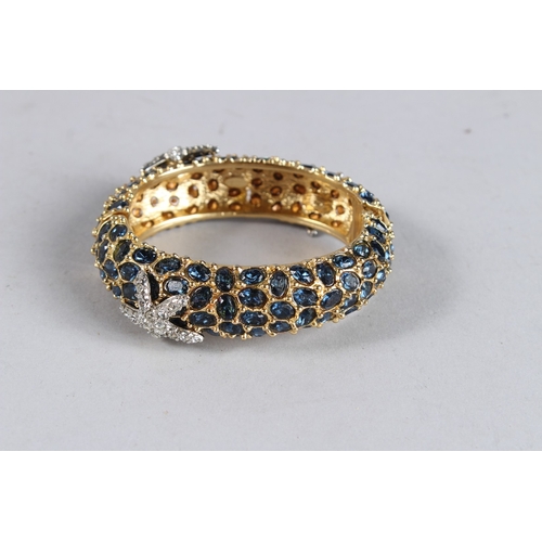 376 - A DIAMANTE BANGLE with black stones.