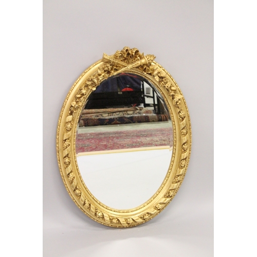 41 - A LOUIS XVI STYLE GILTWOOD OVAL MIRROR.